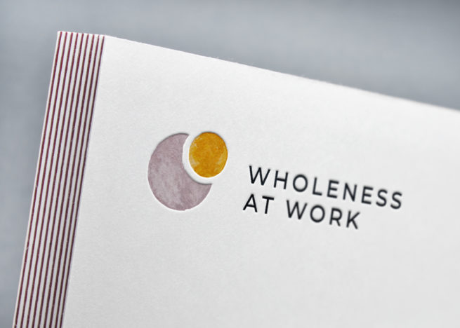 Wholeness Branding: detail shot of logo on business card, embossed