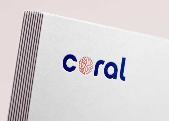 Research Lab Branding San Diego: CORAL logo embossed on a business card